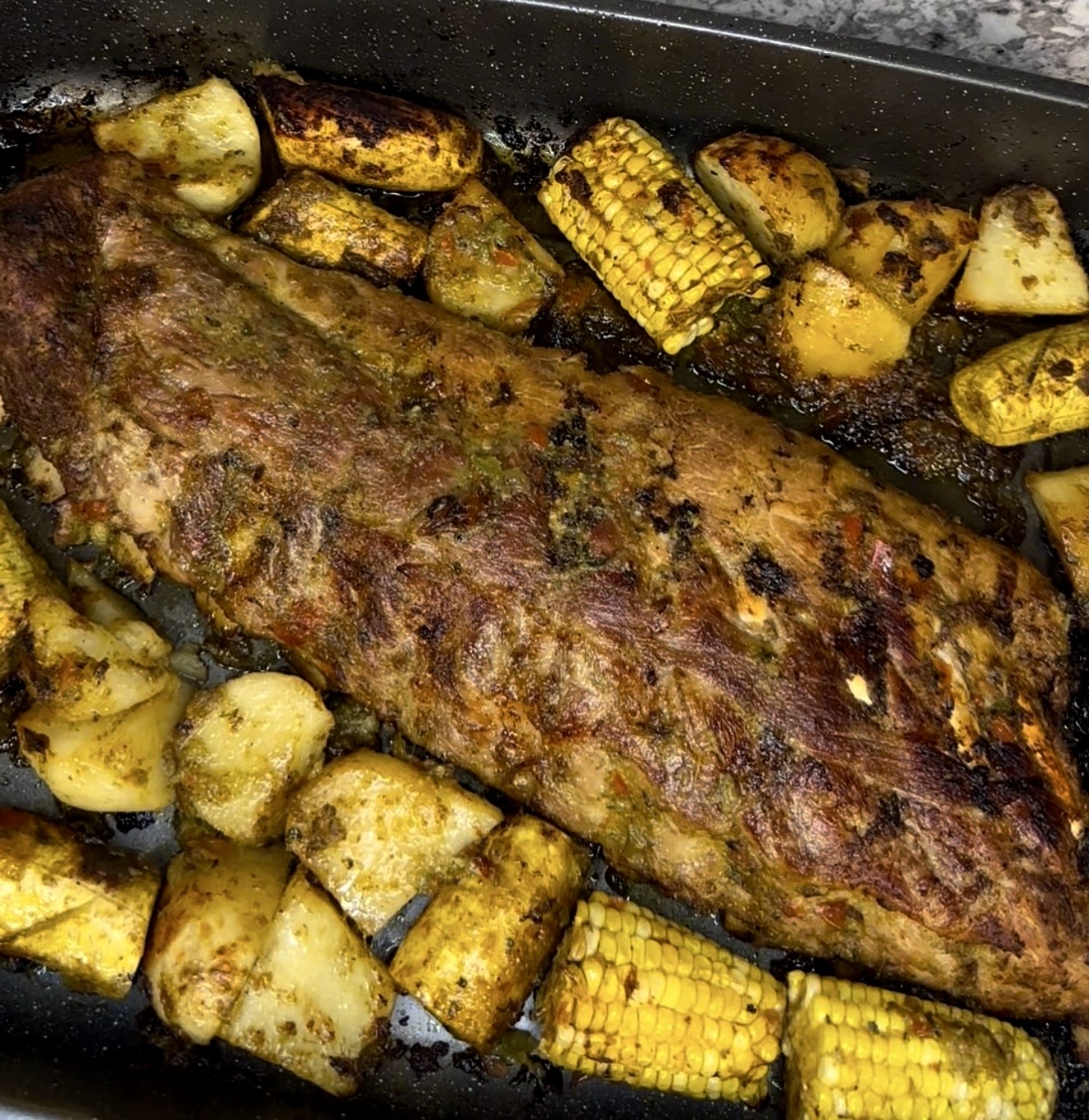 Grilled pork rib tray with corn and potatoes